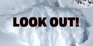A closeup of a big white avalanche with the words "LOOK OUT!" over top.