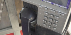 A closeup of a payphone. It looks a little grimey.