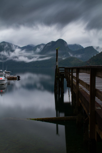 A dock stretches out into the water in misty Zeballos.