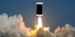 An iPhone rides a rocket ship as it takes off.