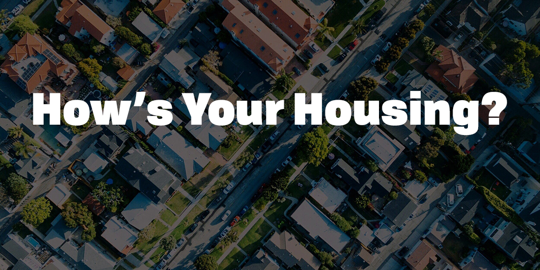 An aerial photo of roofs with the words "How's your housing?" over top.