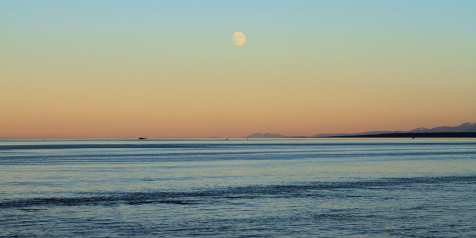 A full moon rises over the ocean off of Campbell River.
