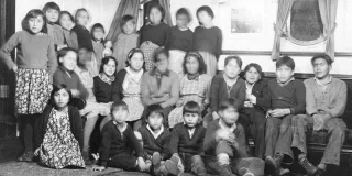 A black-and-white photo of children in sitting room of Alberni Residential School