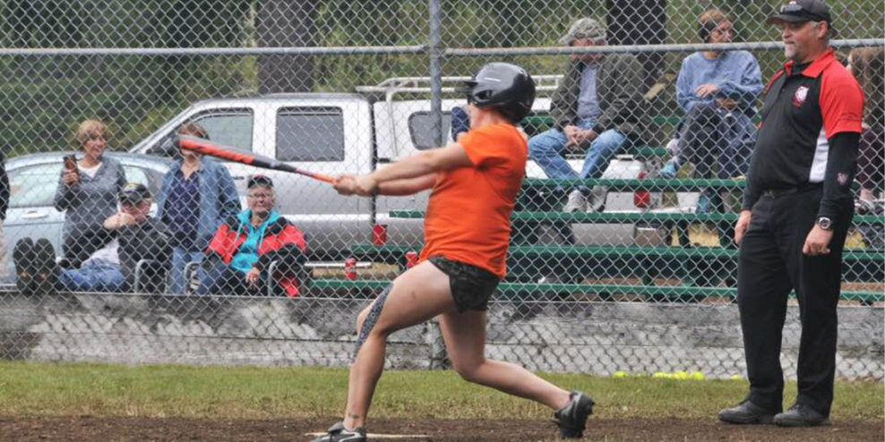 A batter in an orange jersey takes a wicked swing at a pitch.