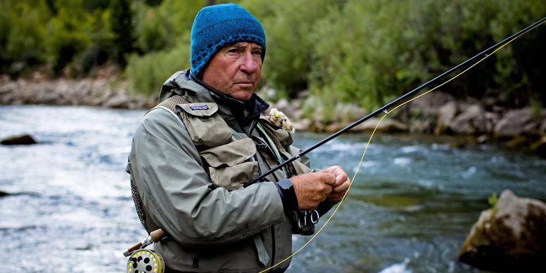 Yvon Chouinard fishes in a river.