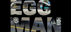 The words EGG MAN on a black background with a picture of a van with broken windows showing through the text.