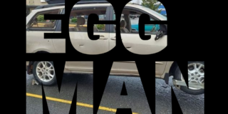 The words EGG MAN on a black background with a picture of a van with broken windows showing through the text.