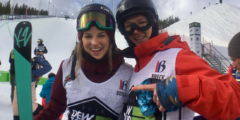 Cassie and Darcy Sharpe pose after a competition in front of a ski hill.