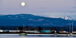 The full moon sets over the Comox Glacier.