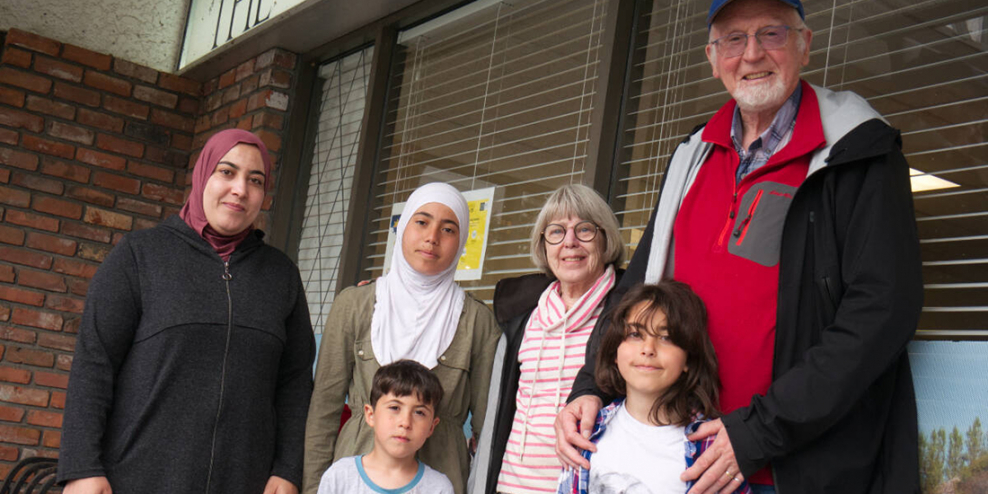 Samar Al Hbayo and her children stand with members of the Ali Refugee Sponsorship Group.