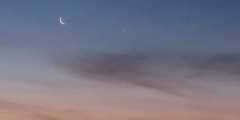 A crescent moon at sunrise.