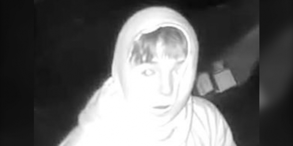 A black-and-white photo from surveillance cameras of a teenage boy in a hoodie.