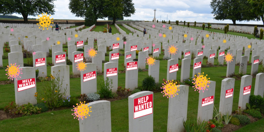 Row after row of gravestones for war dead with "help wanted" signs and COVID particles all over them.