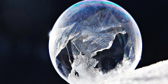 A frozen bubble with holes on a black background.